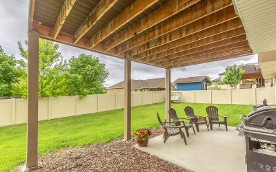 How do arbors influence the aesthetic and design of a backyard garden?